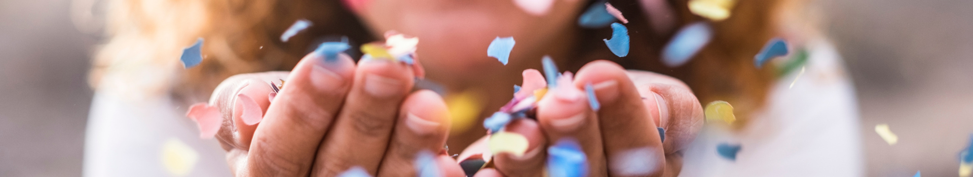 hands with blowing confetti