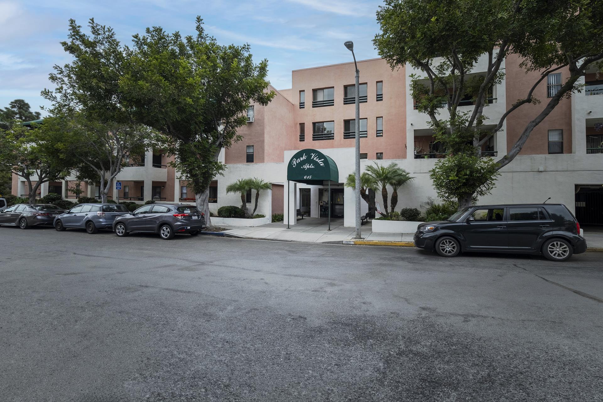 Park Vista Exterior of pink building with road and cars