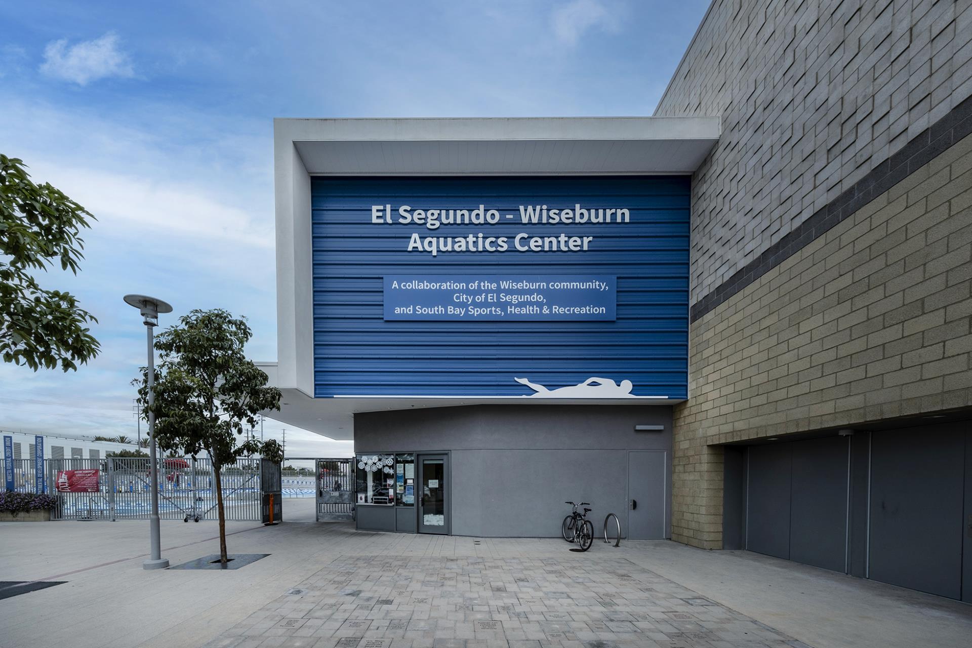 ES Wiseburn Aquatics Exterior sign with trees and entrance