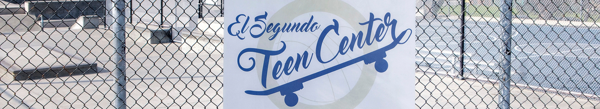 El Segundo Teen Cetner Skae Park sign, fence, skate park behind