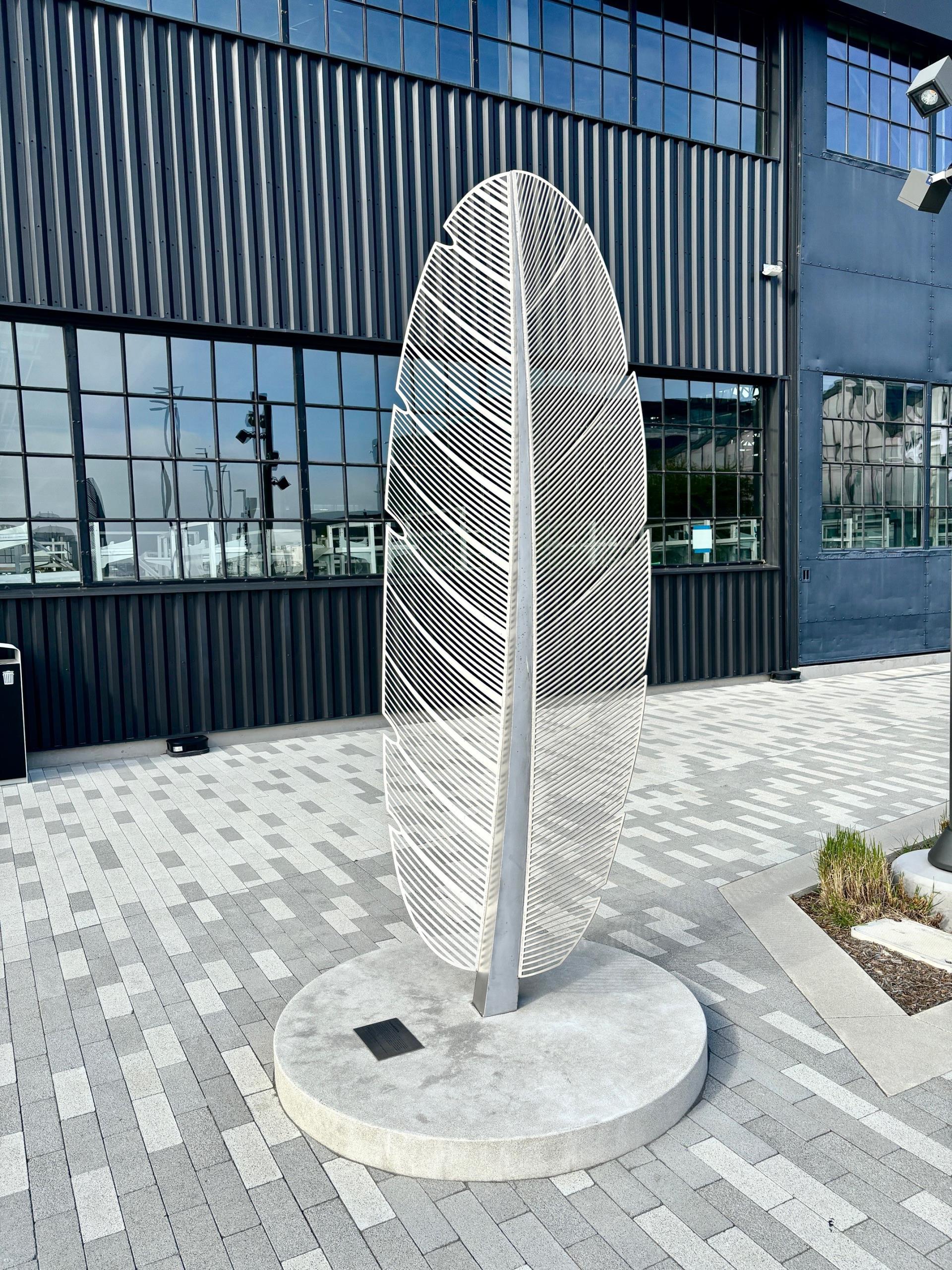 Metal sculpture of feather outside